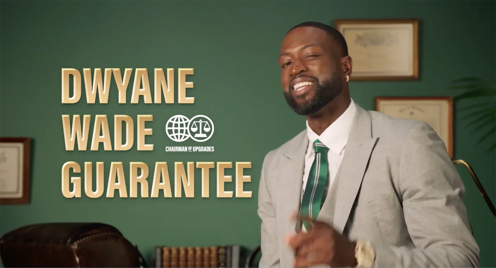 Basketball star Dwyane Wade smiling in a suit with text overlay identifying him as the "Chairman of Upgrades".