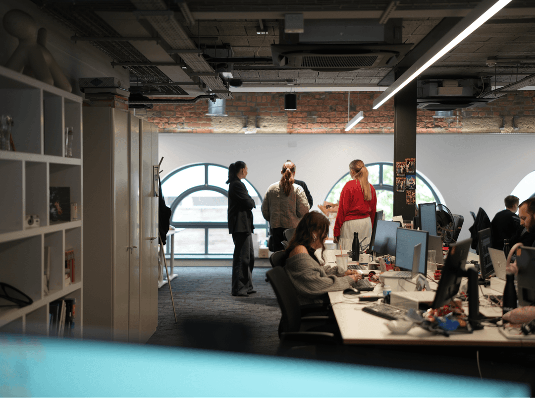 Team members gathered in a contemporary Johannesburg office with industrial ceilings and large windows.