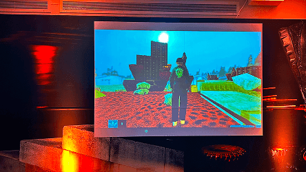 A large digital screen displaying vibrant game graphics at the Mike Arnold launch event.