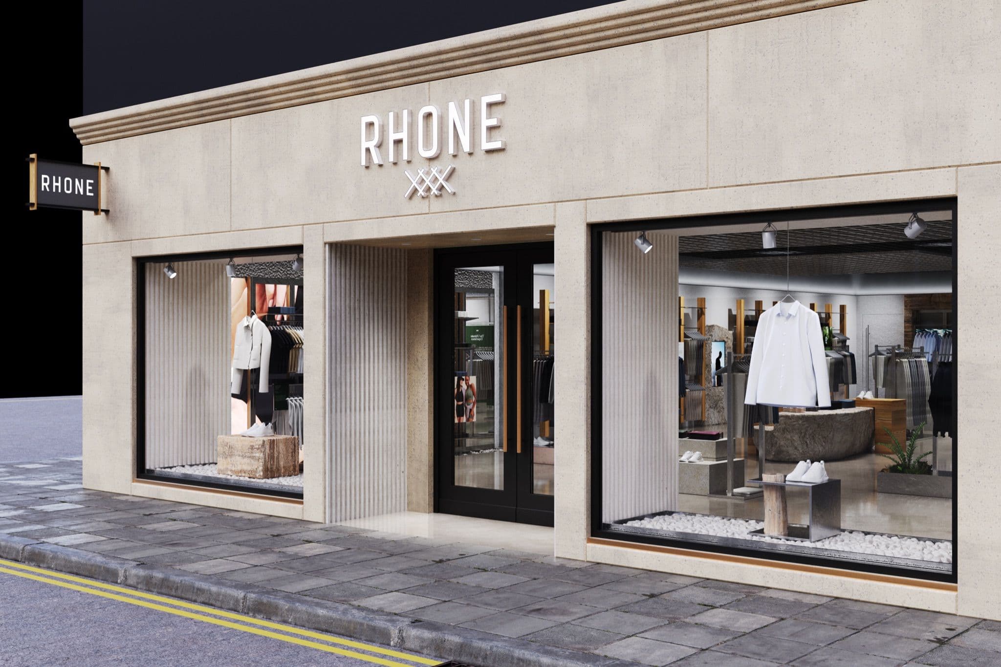 Exterior of a Rhone retail store with large glass windows and a modern stone facade.